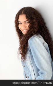 Portrait of smiling teenager leaning on wall