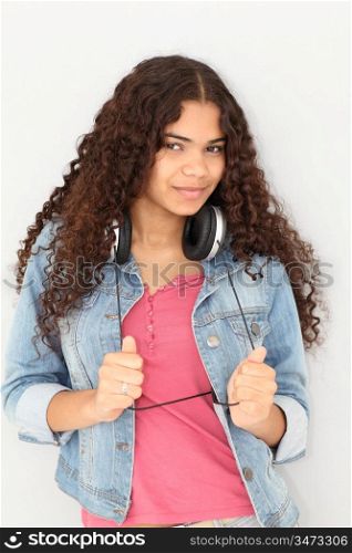 Portrait of smiling teenager listening to music