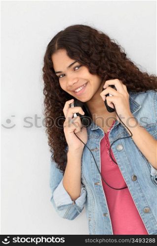 Portrait of smiling teenager listening to music