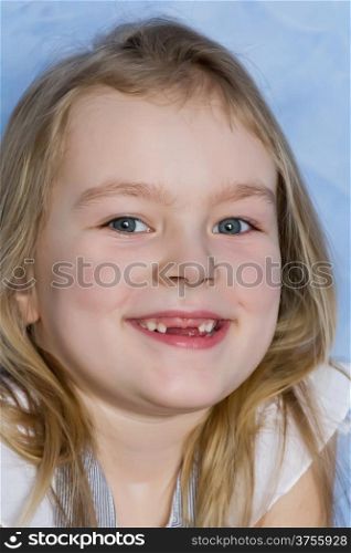 Portrait of smiling toothless girl with blond hair