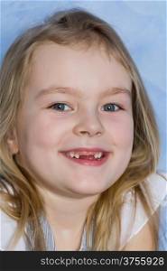 Portrait of smiling toothless girl with blond hair