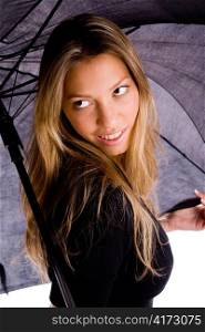 portrait of smiling woman carrying umbrella on an isolated background