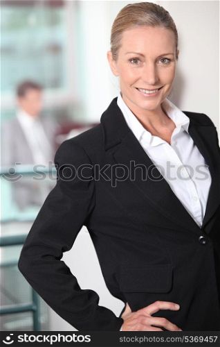 Portrait of smiling woman in black suit