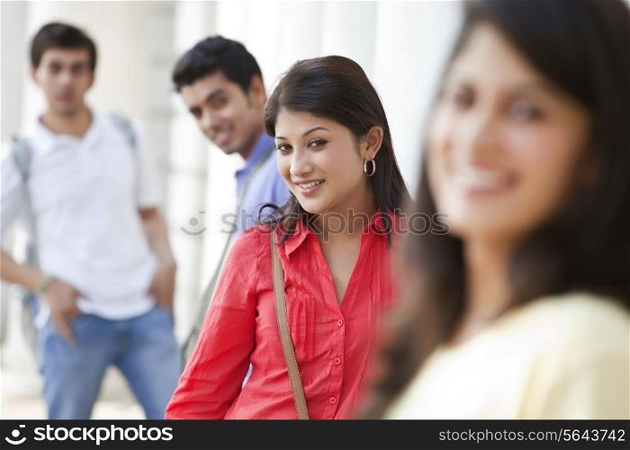 Portrait of smiling woman standing with friends