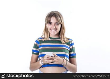 Portrait of smiling woman using mobile phone, chatting, texting message, standing in t-shirt over white background