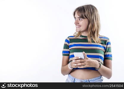 Portrait of smiling woman using mobile phone, chatting, texting message, standing in t-shirt over white background