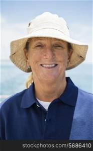 Portrait of smiling woman wearing hat on yacht