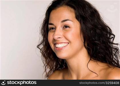 Portrait of smiling woman with bare shoulders.