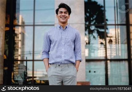 Portrait of Smiling Young Asian Businessman in the City. a Happy Friendly Man