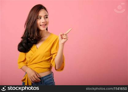 portrait of smiling young asian woman in casual clothing. studio shot
