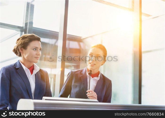 Portrait of smiling young attractive passenger service agent standing in airport