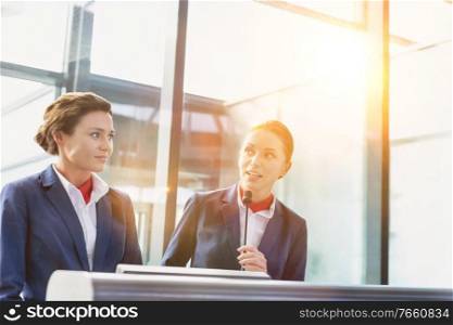 Portrait of smiling young attractive passenger service agent standing in airport