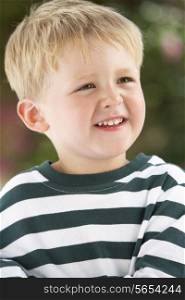 Portrait Of Smiling Young Boy Outdoors