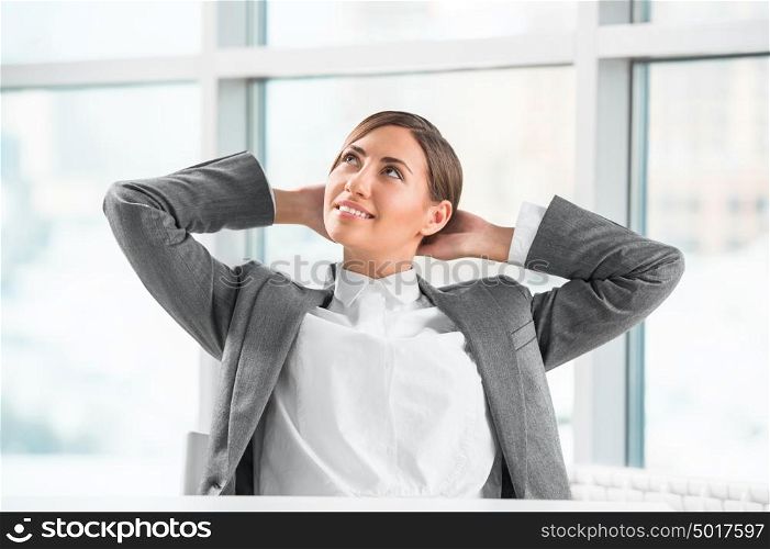Portrait of smiling young business woman relaxing at office