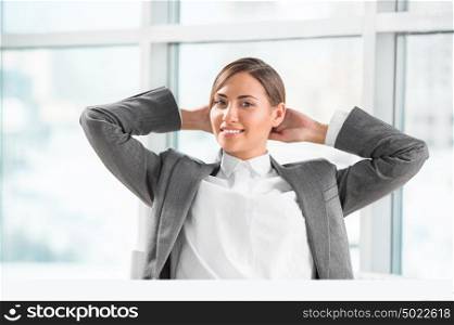 Portrait of smiling young business woman relaxing at office