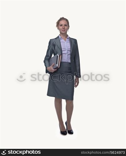 Portrait of smiling young businesswoman holding digital tablet and books, full length, studio shot