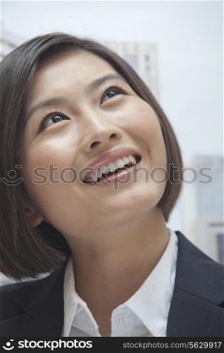 Portrait of Smiling Young Businesswoman, Looking up