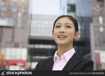Portrait of smiling young businesswoman, outdoors, Beijing, China