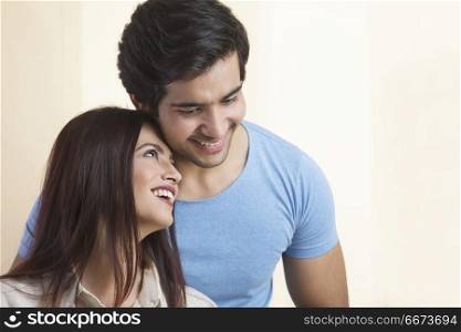 Portrait of smiling young couple hugging