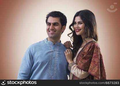 Portrait of smiling young couple in traditional dress