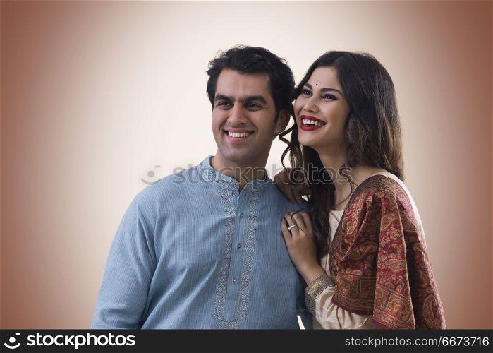 Portrait of smiling young couple in traditional dress