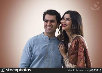 Portrait of smiling young couple in traditional dress