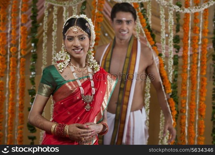 Portrait of smiling young couple on their wedding day