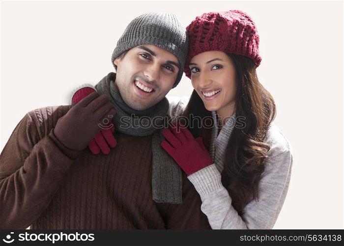 Portrait of smiling young couple over white background