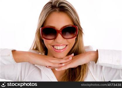 portrait of smiling young female wearing sunglasses against white background