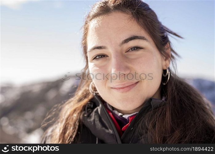 Portrait of smiling young hispanic woman outdoor, looking camera