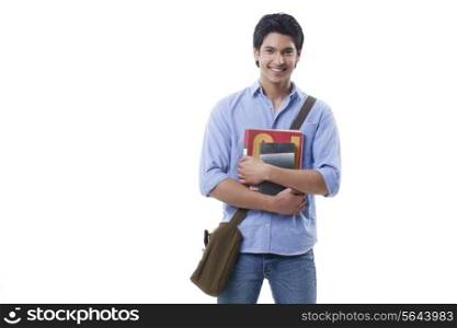 Portrait of smiling young man holding books