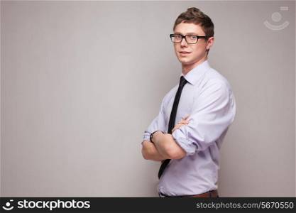 portrait of smiling young man in glasses and formal wear