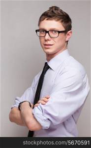 portrait of smiling young man in glasses and formal wear