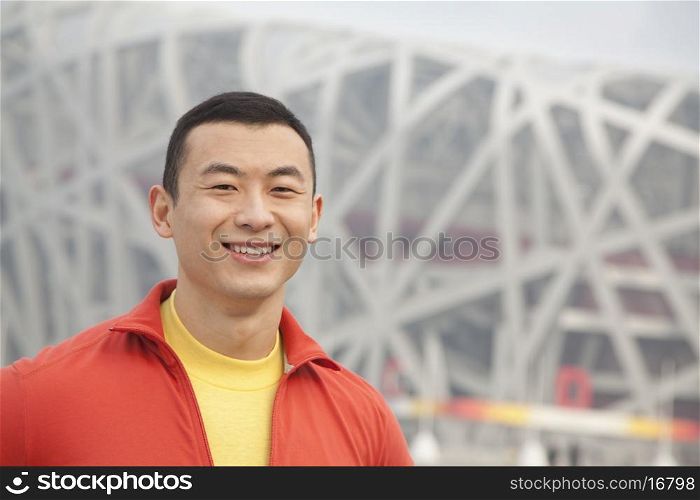 Portrait of smiling young man in park, Beijing, close-up