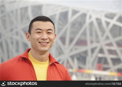 Portrait of smiling young man in park, Beijing, close-up
