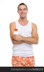 Portrait of smiling young man showing sun screen creme