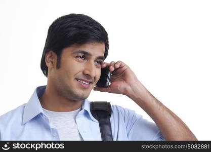 Portrait of smiling young man talking on mobile phone