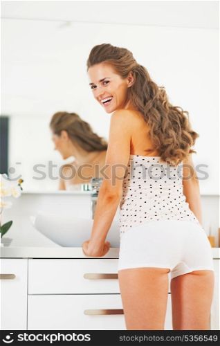 Portrait of smiling young woman in bathroom
