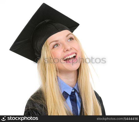 Portrait of smiling young woman in graduation gown looking on copy space