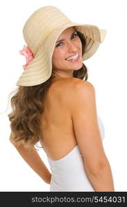 Portrait of smiling young woman in swimsuit and hat