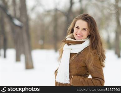 Portrait of smiling young woman in winter park