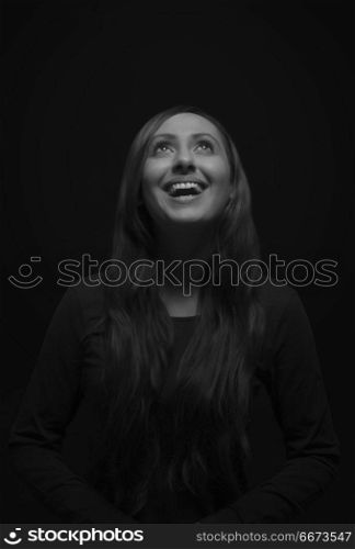 Portrait of smiling young woman looking up
