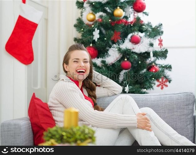 Portrait of smiling young woman near Christmas tree