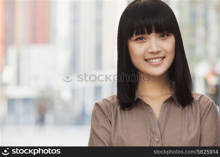 Portrait of Smiling Young Woman Outdoors in Beijing