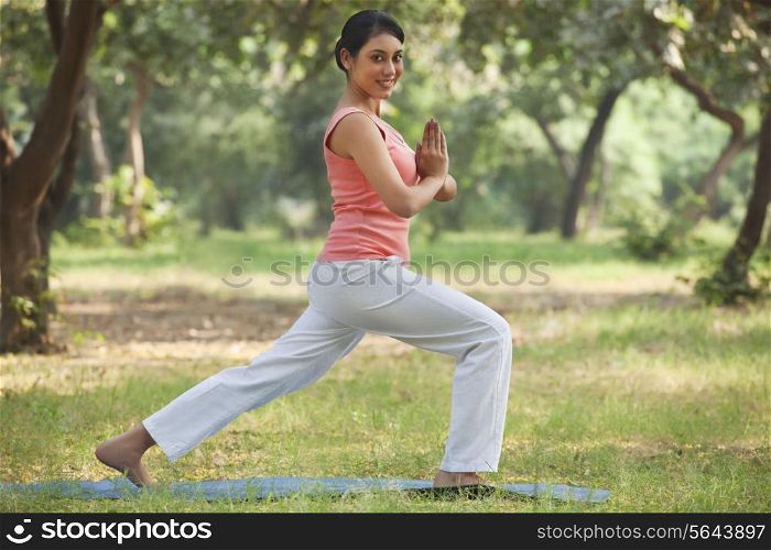 Portrait of smiling young woman practicing yoga