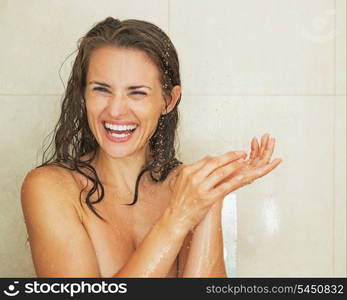 Portrait of smiling young woman taking shower