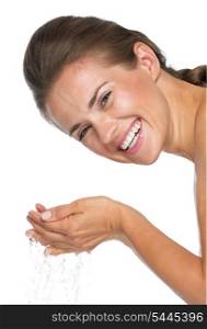 Portrait of smiling young woman washing face