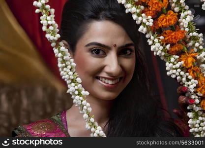 Portrait of smiling young woman with wreath