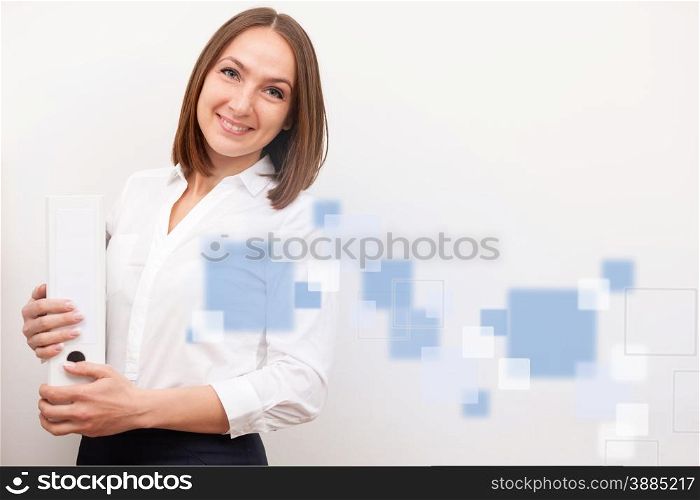 Portrait of smilng businesswoman is standing with a folder over white isolated background