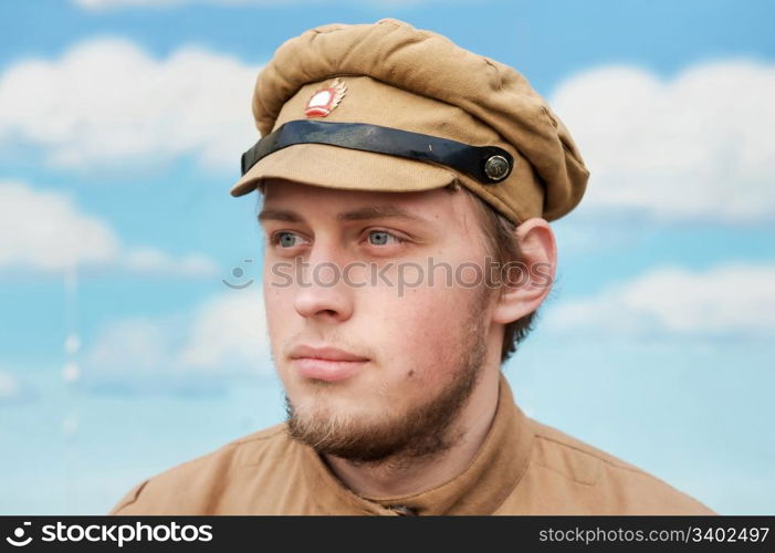 Portrait of soldier in uniform of World War 1 on the background of blue sky. Costume accord the times of World War I. Photo made at cinema city Cinevilla in Latvia. Cockade on the hat do not contain trade mark.